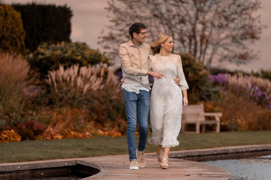 couple engaged walking around the gardens for their summer engagement