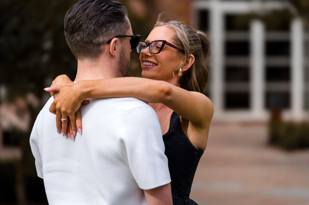 engaged couple facing each other and smiling