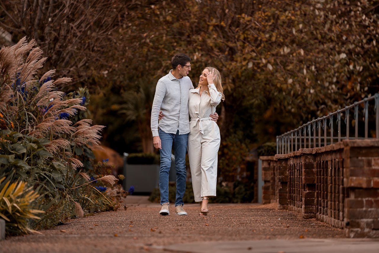 couple walking hand in hand through the grove gardens